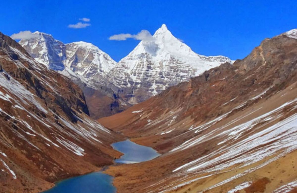 An alpine lake below high snow peaks