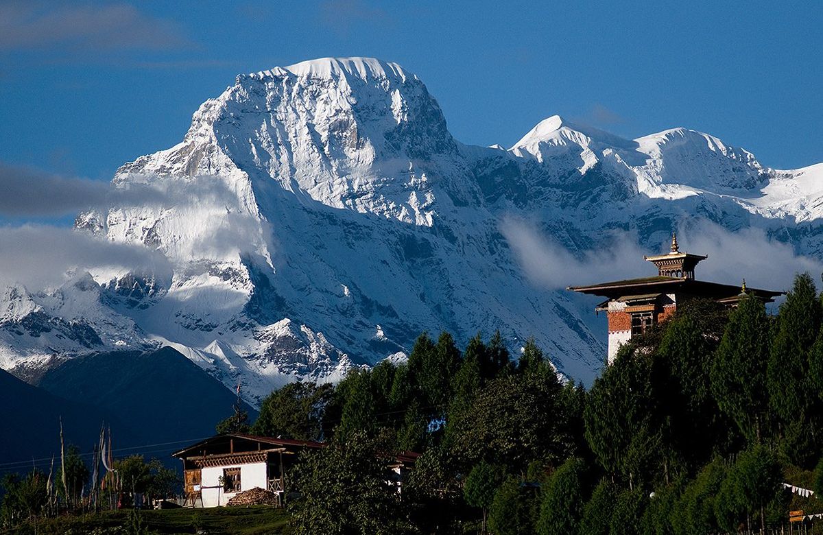 Snow peaks above a temple roof in the western Himalaya